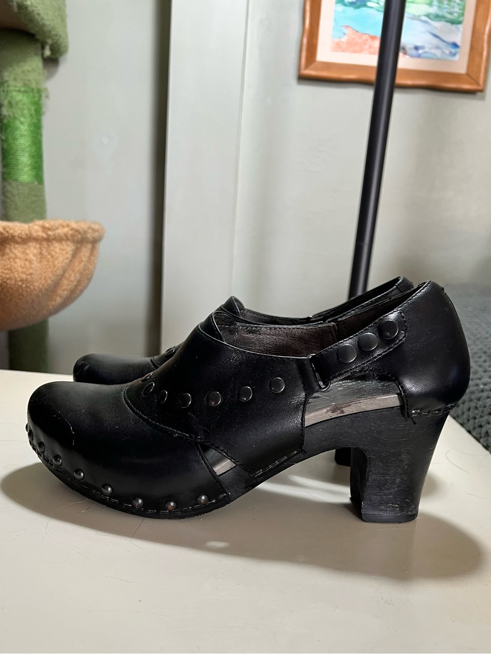 Dansko Ryder Black Leather clogs with silver studded details and block heels.